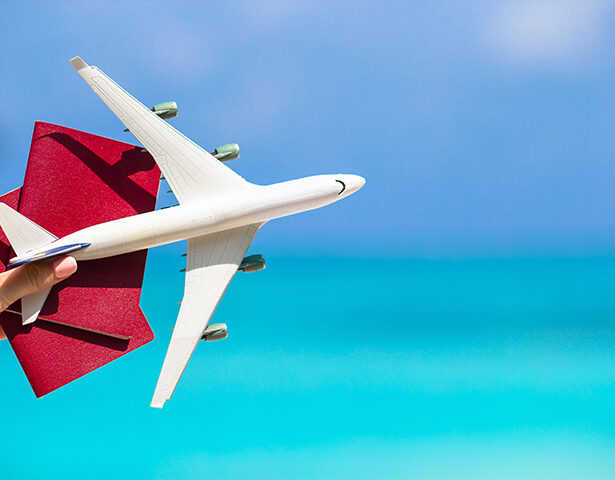 Closeup of passports and white airplane background the sea