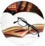 Legal books with glasses on open pages, symbolizing legal research and expertise. Legal books and reading glasses on open pages, representing law practice and legal consultation.
